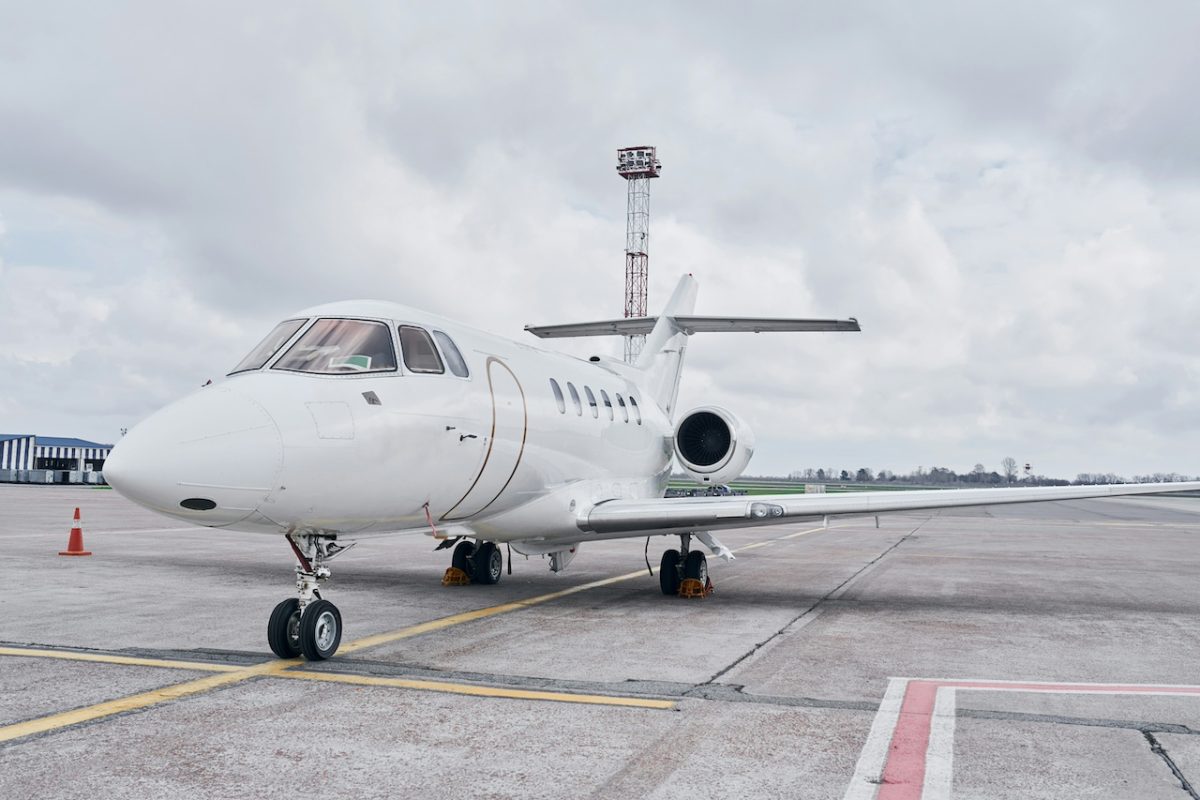White Cessna Citation business jet parked on runway at Milan Linate Airport