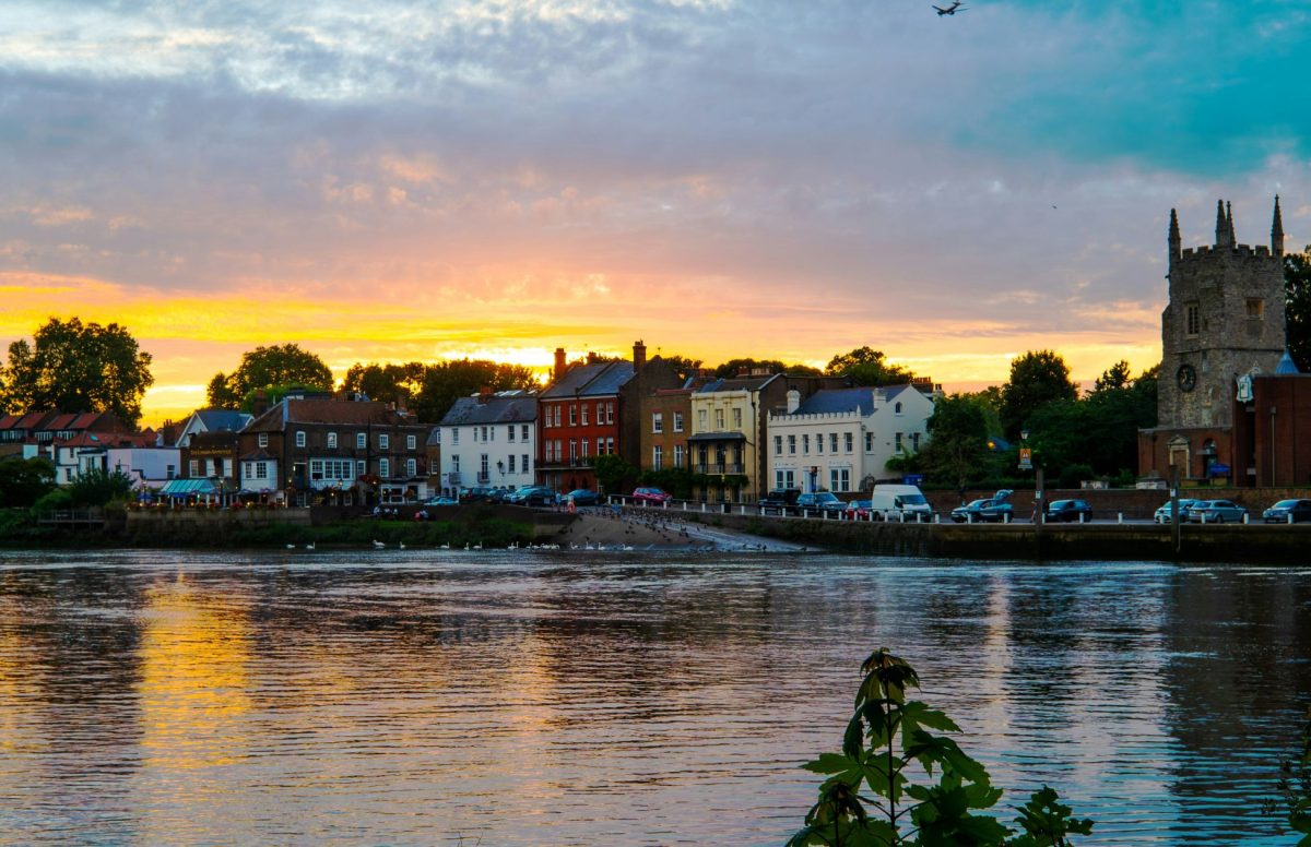 Richmond riverside at sunset with colorful buildings and church tower reflected in water