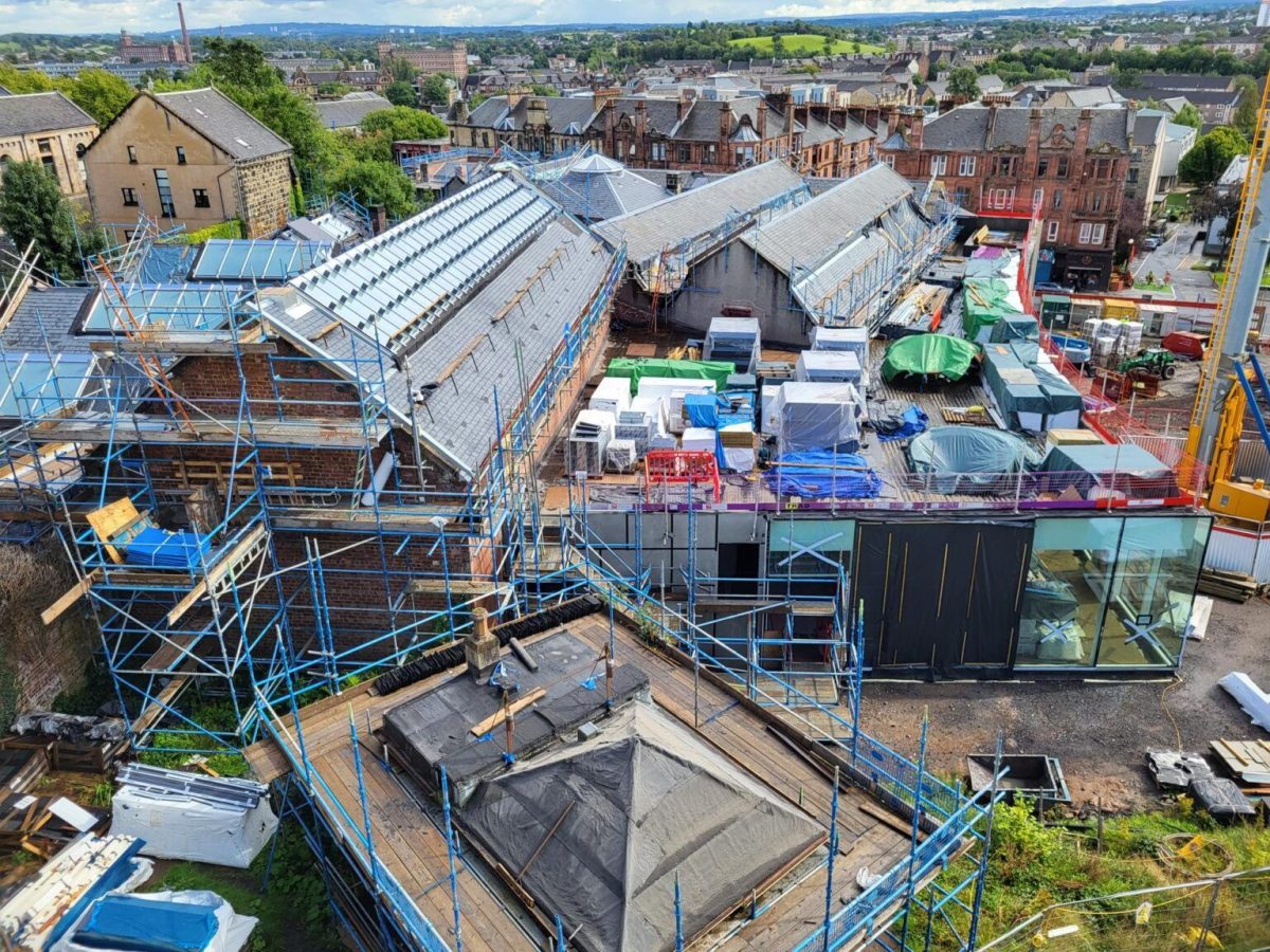 Aerial view of a Scottish museum building undergoing extensive renovation with scaffolding and construction materials