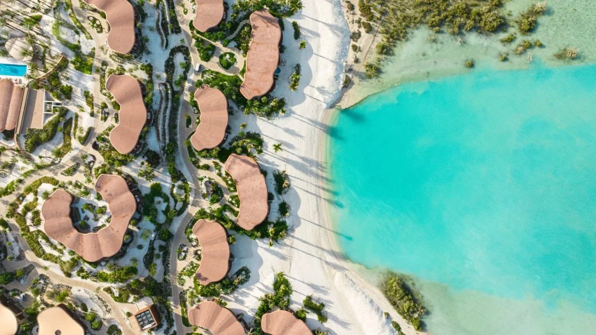 Aerial view of Four Seasons Red Sea resort with curved buildings and turquoise waters