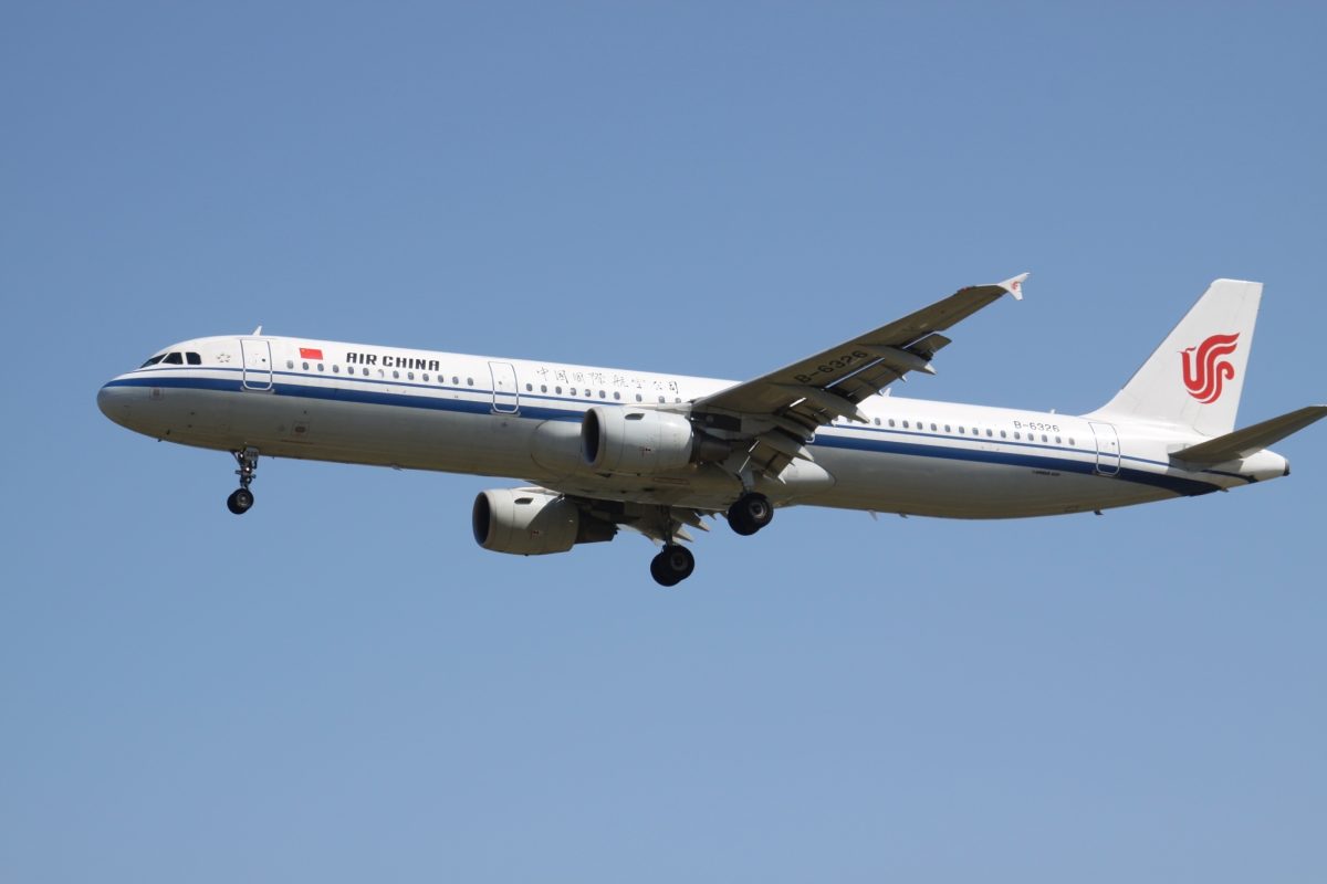 Air China Airbus A321 aircraft in flight against clear blue sky