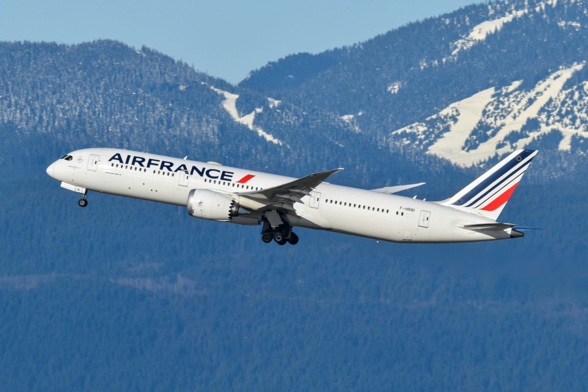 Air France Airbus A350 in flight over snow-covered Alpine mountains
