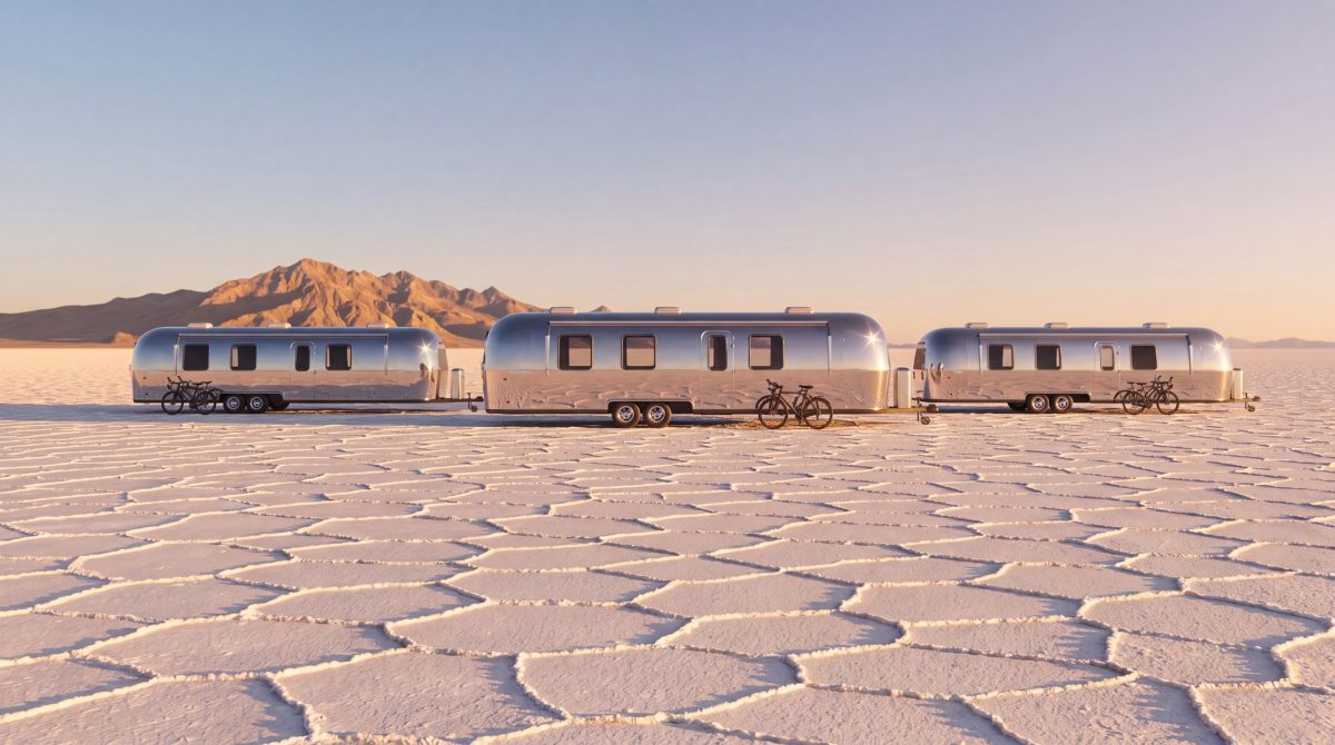 Airstream trailers lined up on the vast, white Salar de Uyuni salt flats.