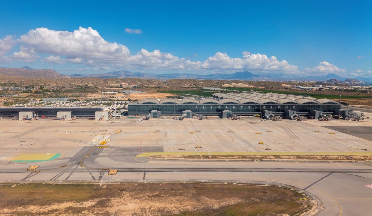 Aerial view of Alicante Airport with runways and terminal buildings in desert landscape
