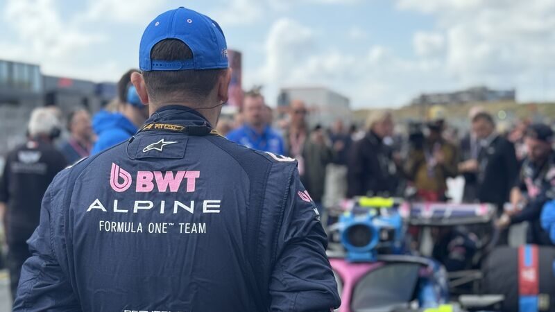 Alpine F1 team member in BWT Alpine gear at Zandvoort circuit with crowd in background