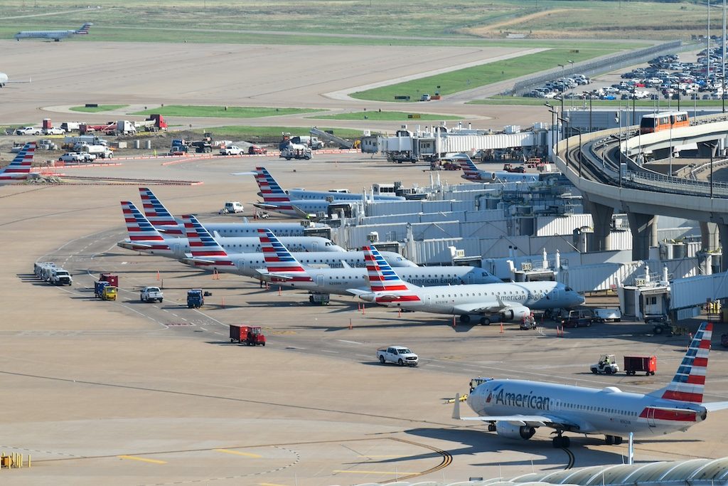 American Airlines aircraft parked at terminal gates during daytime at busy airport