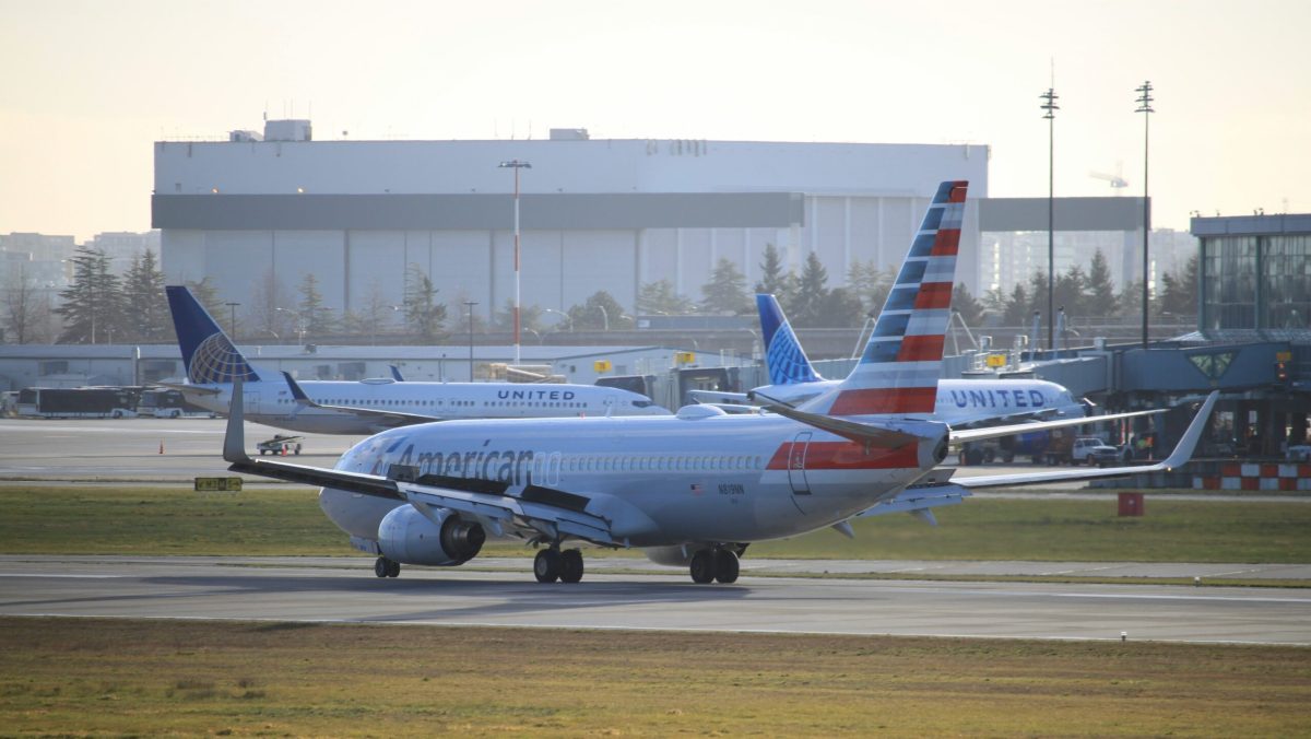 American Airlines Boeing 737 aircraft on airport tarmac with hangar in background