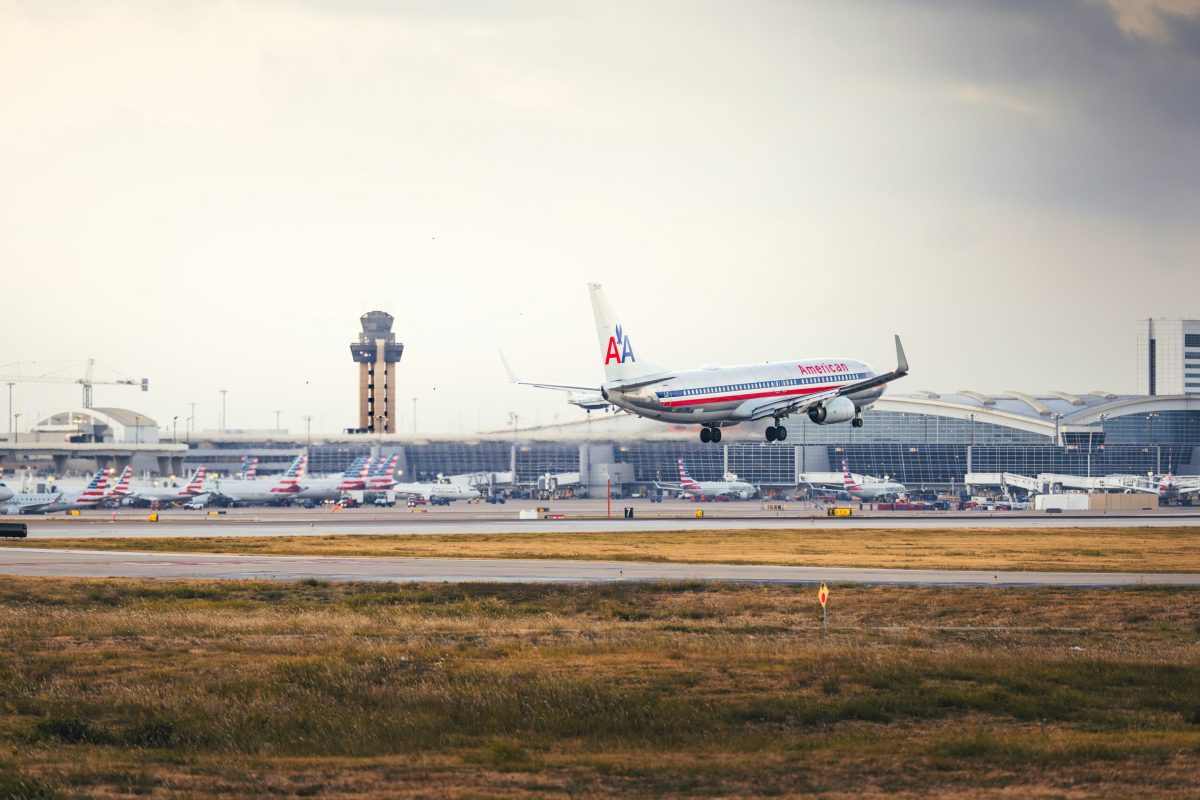 American Airlines plane taking off from a busy airport.