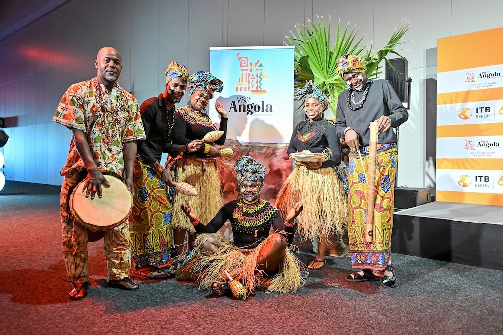 Angolan cultural performers with traditional instruments and attire at ITB Berlin 2026
