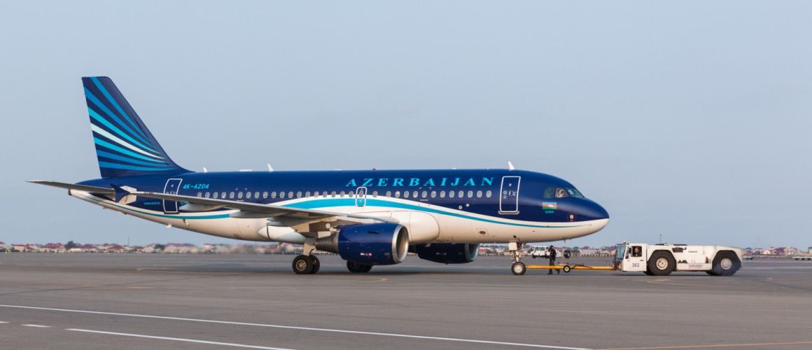 Blue Azerbaijan Airlines Embraer aircraft on airport tarmac