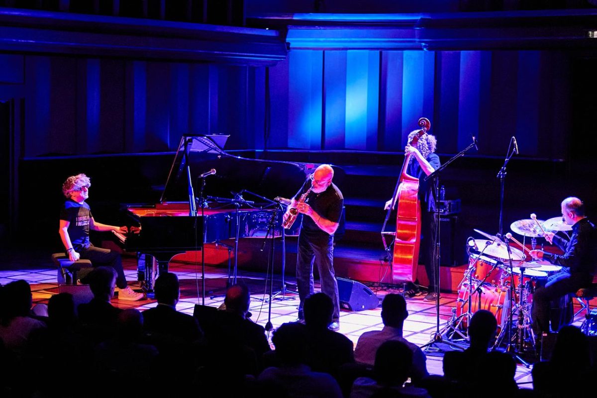 Azerbaijani jazz ensemble performing on stage with blue lighting and silhouetted audience