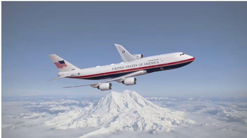 Boeing 747 aircraft in flight over snow-covered mountain peak
