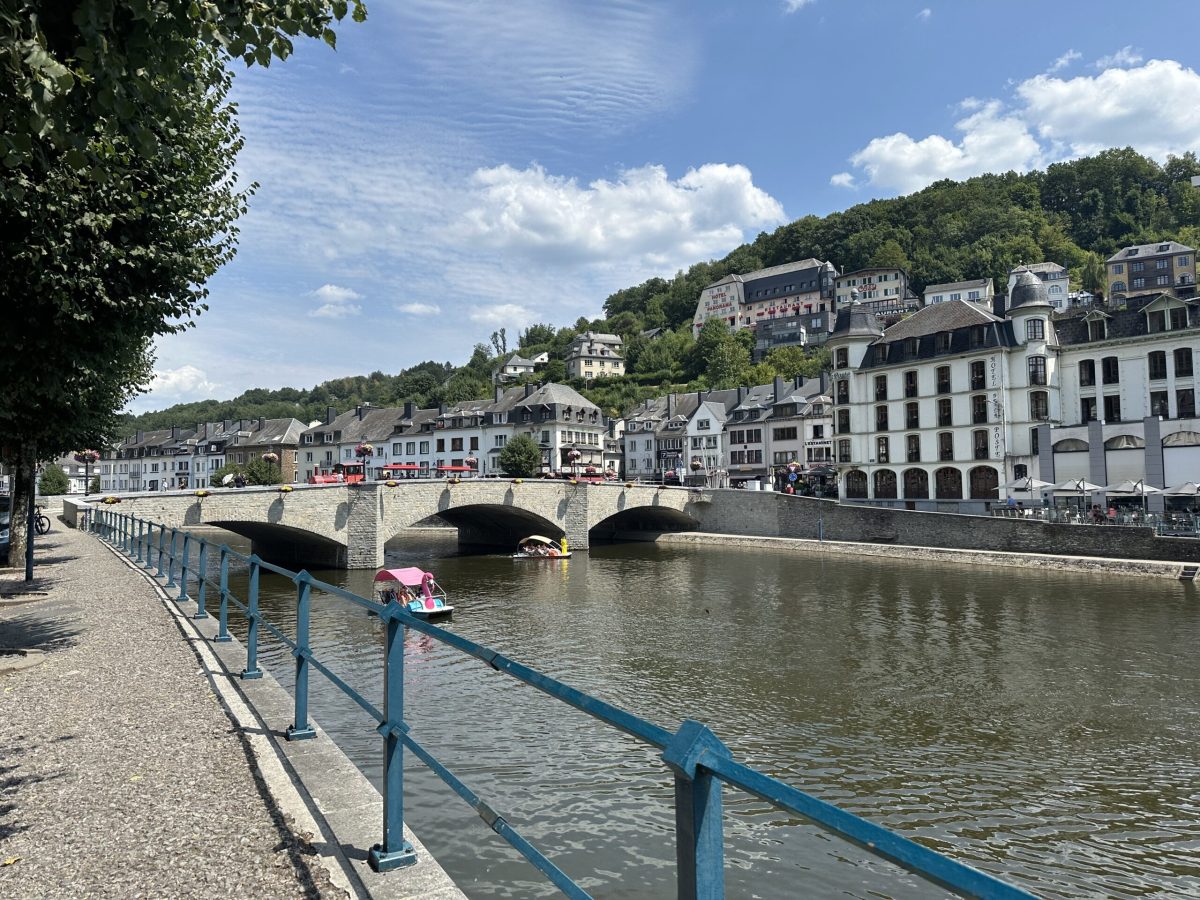 Bouillon's riverside promenade with historic buildings and stone bridge over the River Semois