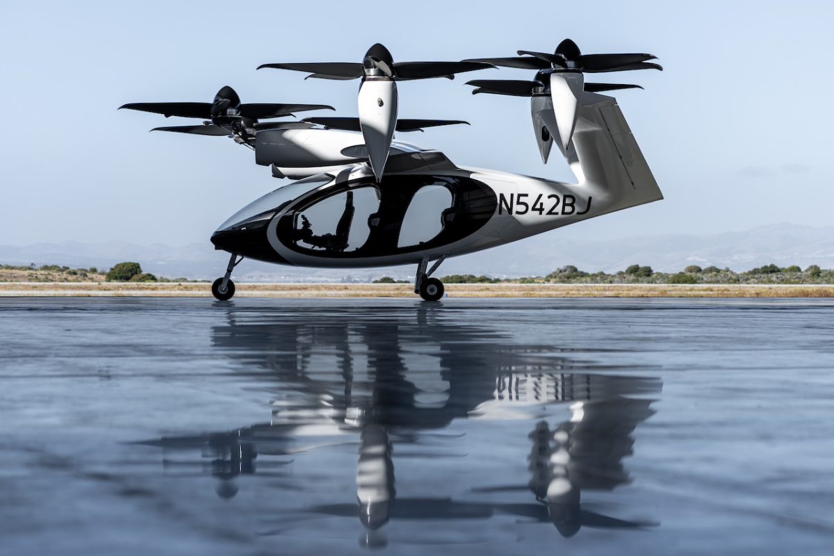 Electric vertical takeoff aircraft (eVTOL) on wet tarmac with registration N542B