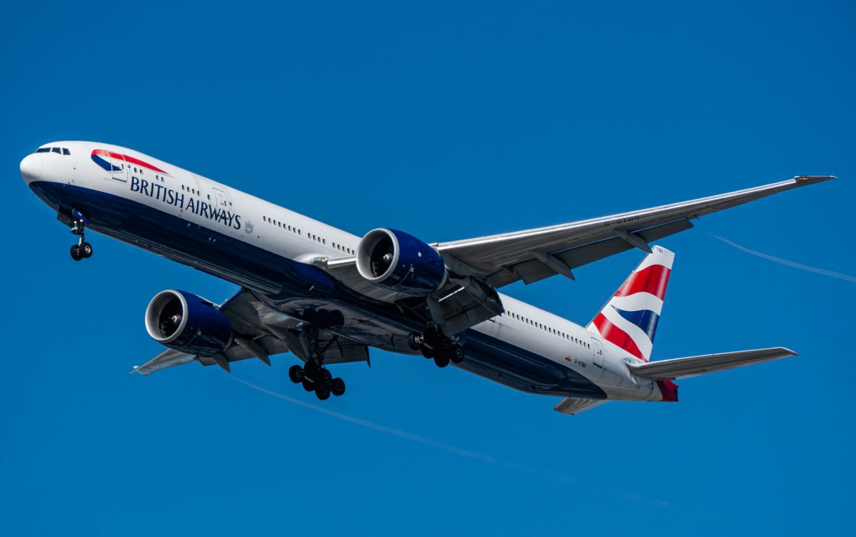 British Airways Boeing 777 aircraft in flight against blue sky