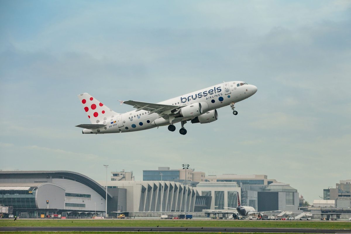 Brussels Airlines Airbus A320 taking off from airport with terminal buildings below