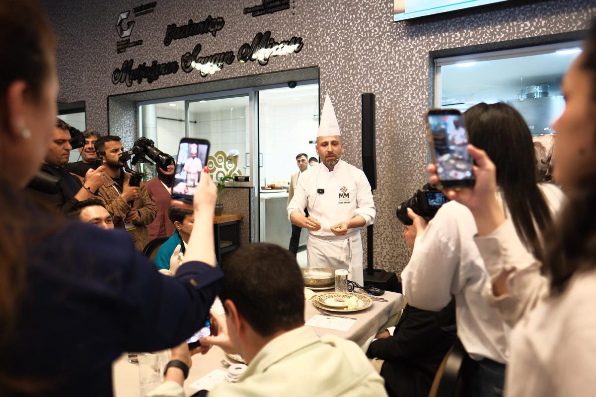 Chef demonstrating traditional Gaziantep cuisine to an engaged crowd of visitors and photographers
