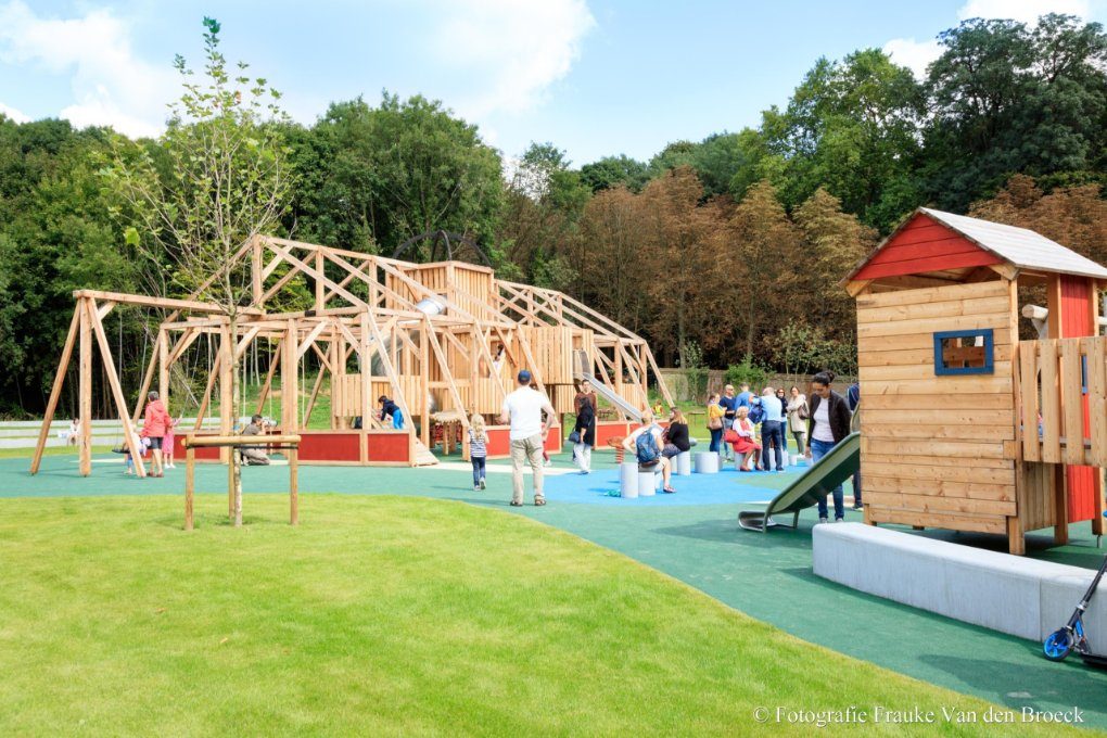 Children playing on colorful playground equipment in Tervuren park