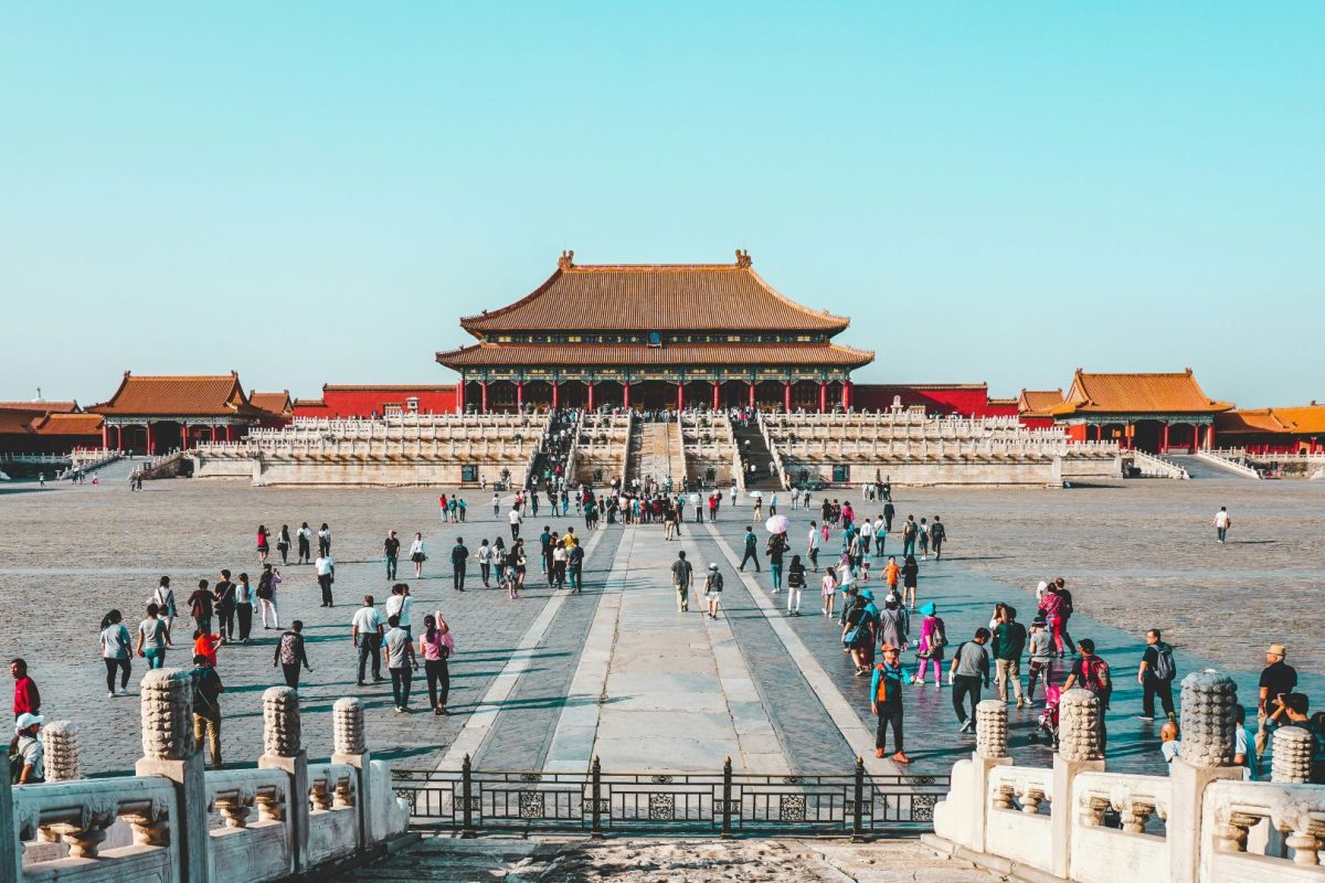 Tourists gathering in the courtyard of the Forbidden City in Beijing under clear skies