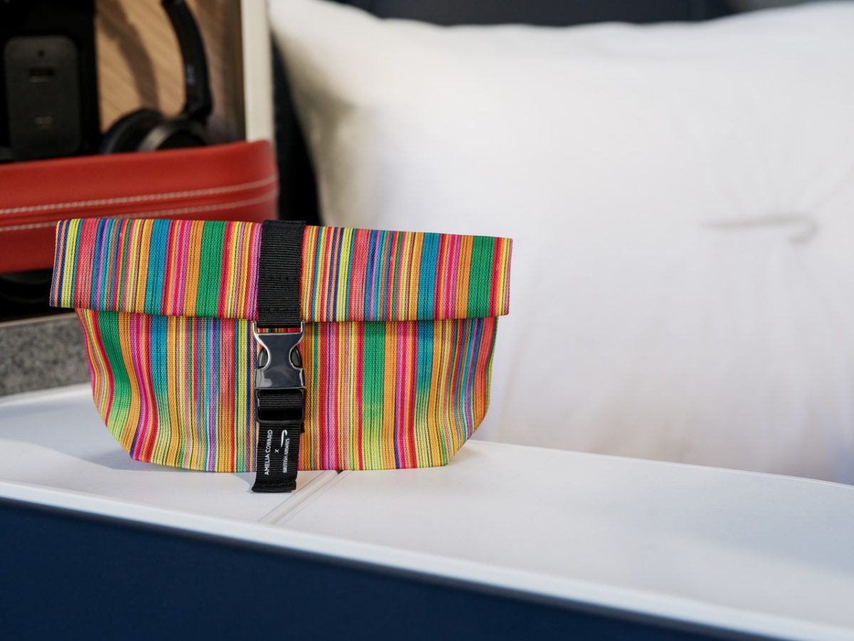 Colorful amenity kit on a British Airways First Class seat.