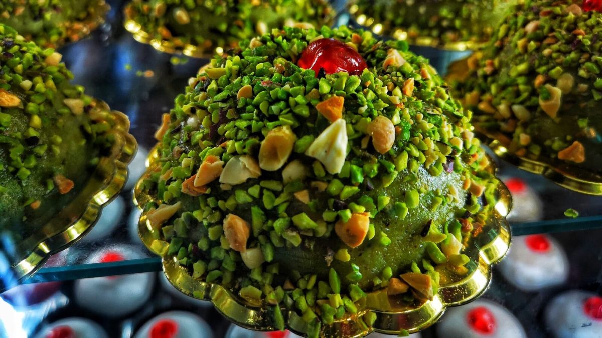 Colorful Sicilian granita topped with crushed pistachios and candied fruits