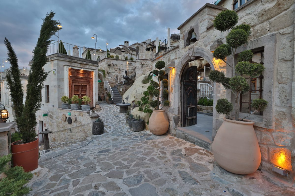 Courtyard of Hilton's cave hotel in Cappadocia with stone architecture and traditional pottery