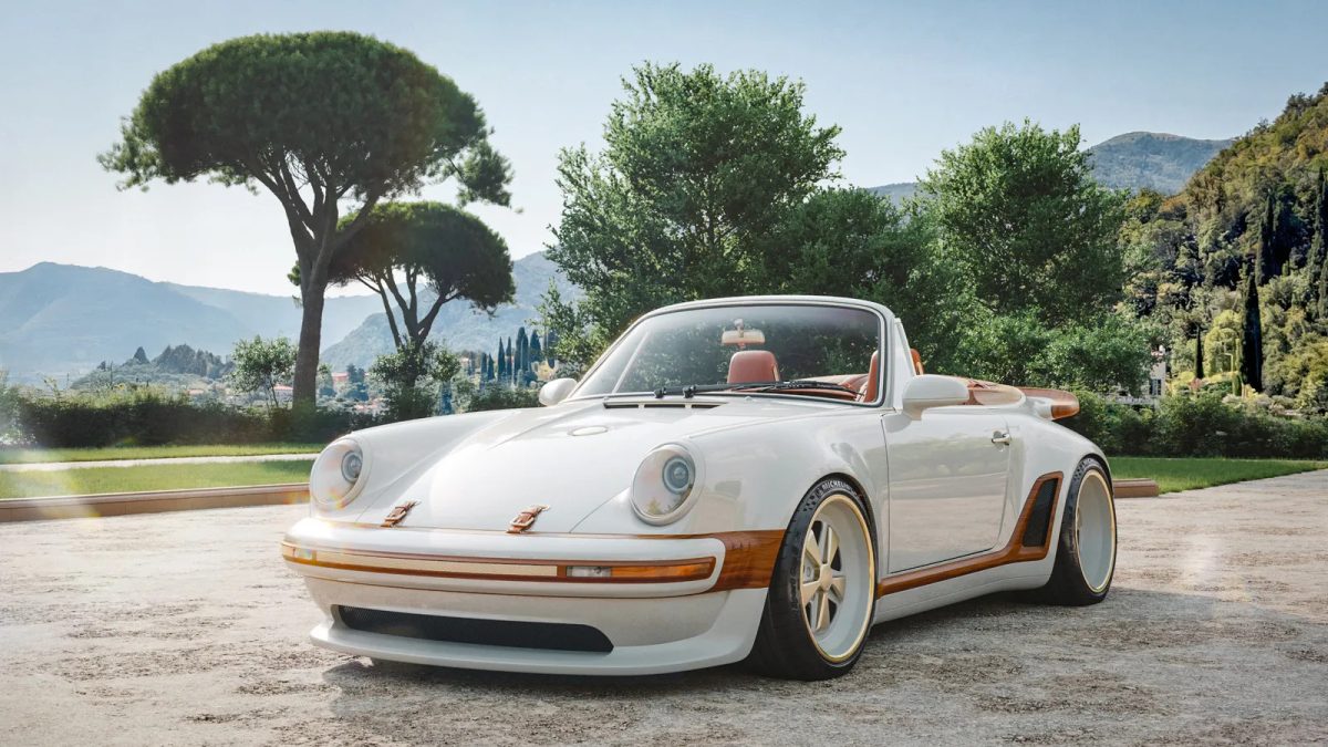 Custom cream-colored Porsche 911 with matching Louis Vuitton luggage in Mediterranean landscape