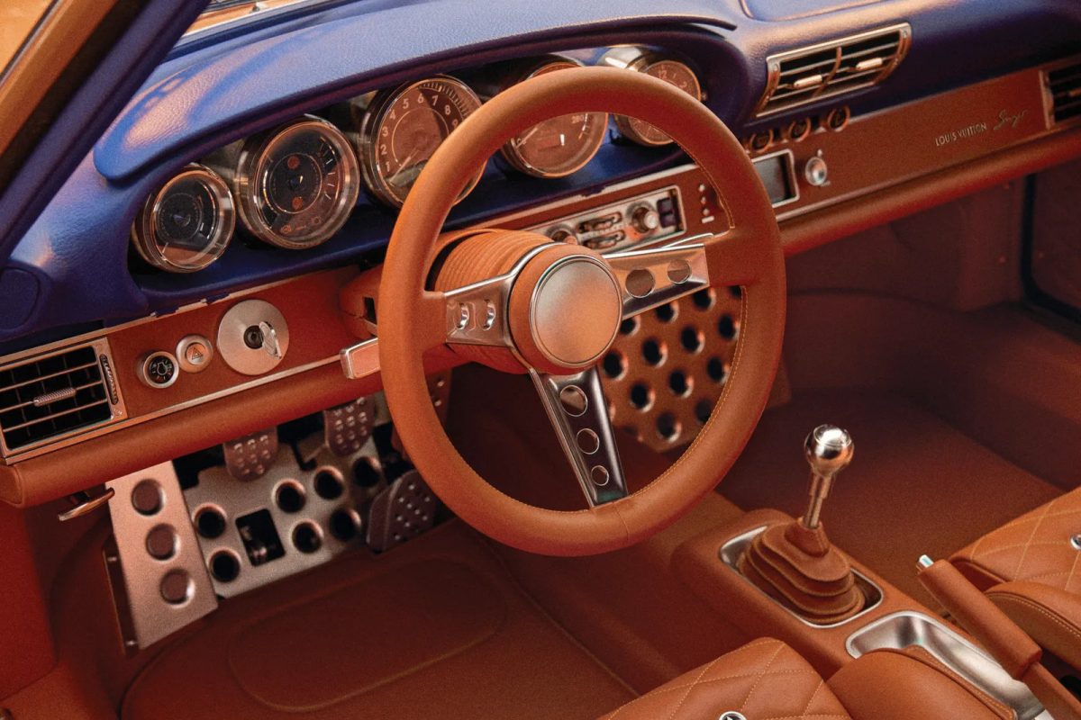 Custom orange Porsche 911 interior with leather steering wheel and matching upholstery