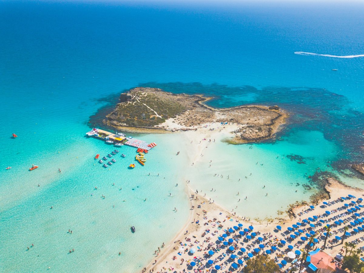 Aerial view of Nissi Beach in Cyprus with turquoise waters and sandy shore