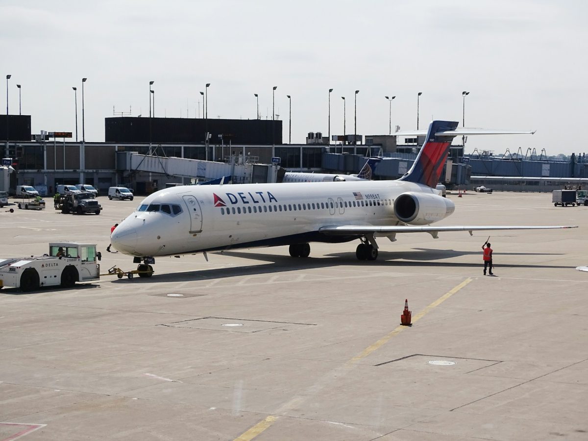 Delta Air Lines aircraft parked at airport gate during daytime