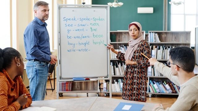 Diverse group of people in a classroom setting discussing during a language or cultural learning session