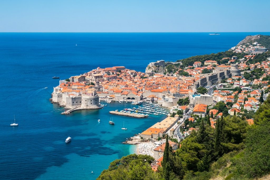 Aerial view of Dubrovnik's walled Old Town peninsula surrounded by turquoise Adriatic waters