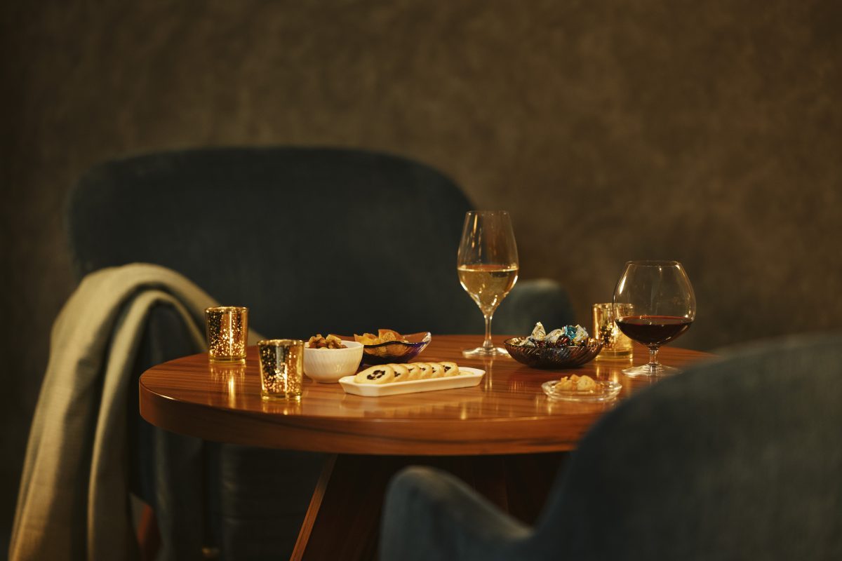 Elegant wine glasses and appetizers on a wooden table in a luxury suite