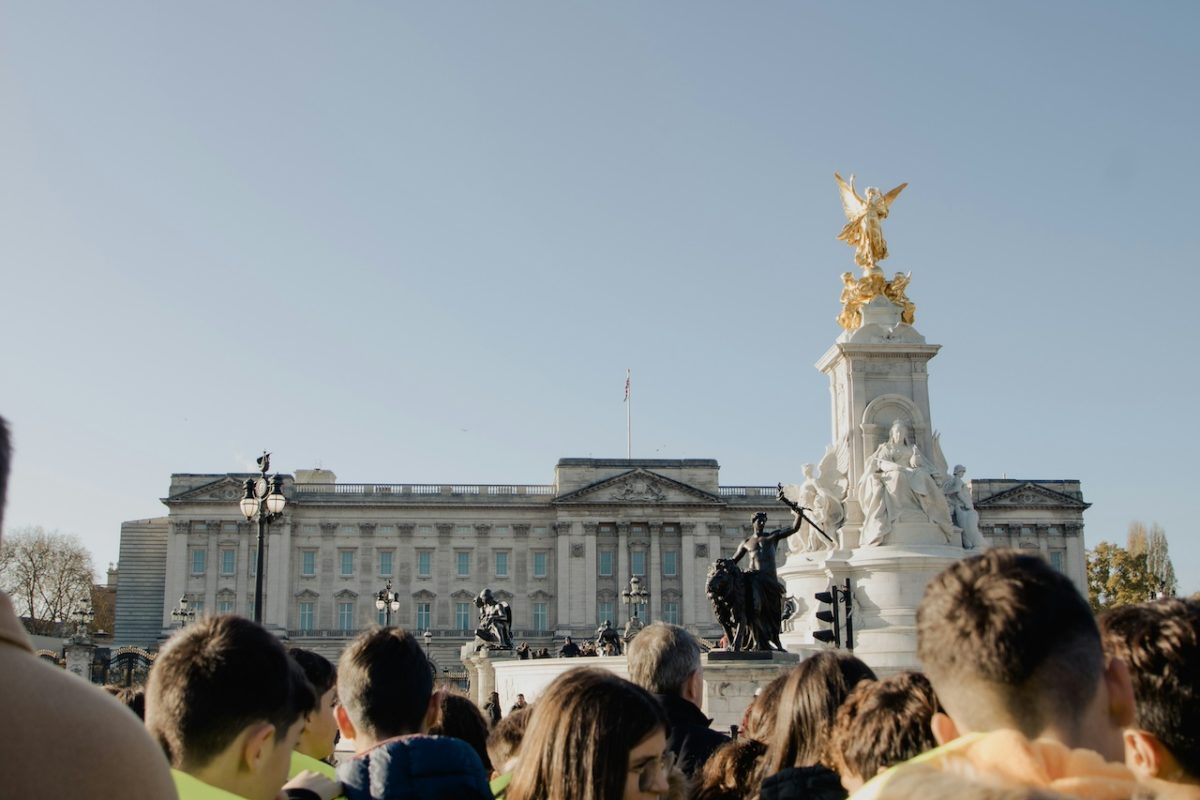 Crowd gathers in front of Victoria Memorial and Buckingham Palace, London.
