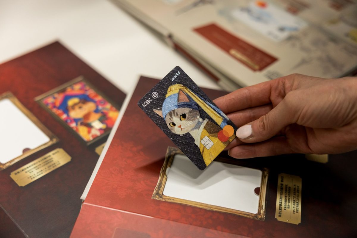 Hand holding a luxury travel card over passport and travel documents