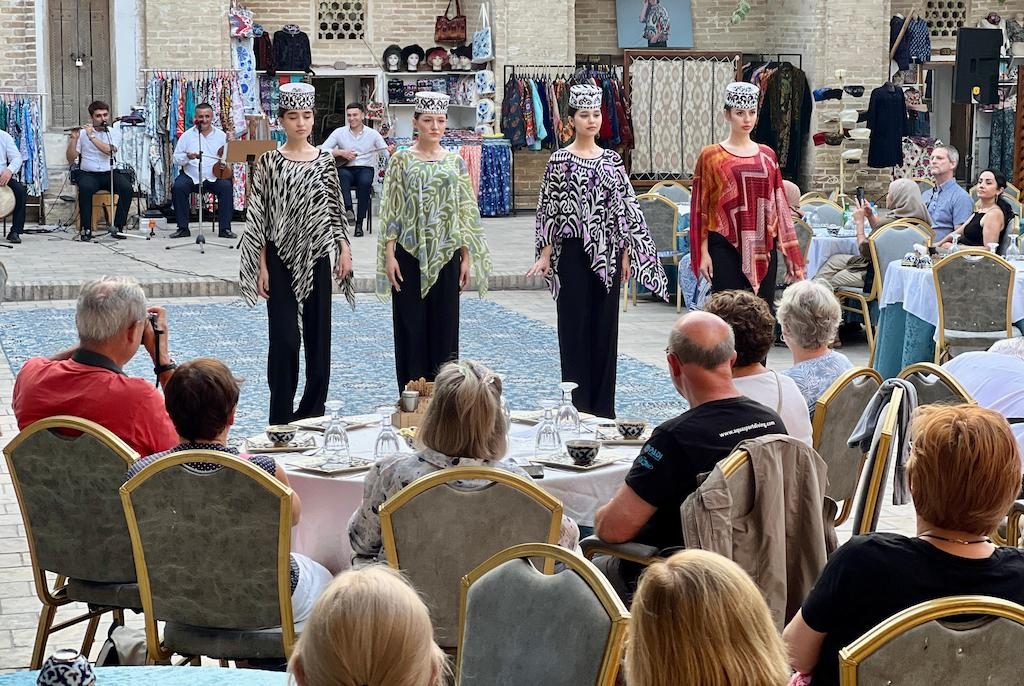 Fashion show performance in Uzbekistan with traditional clothing displayed on stage