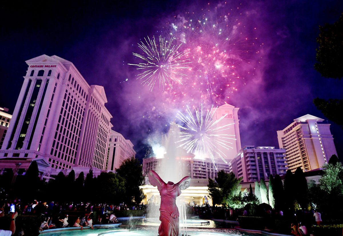 Fireworks explode over Las Vegas casinos and downtown buildings at night