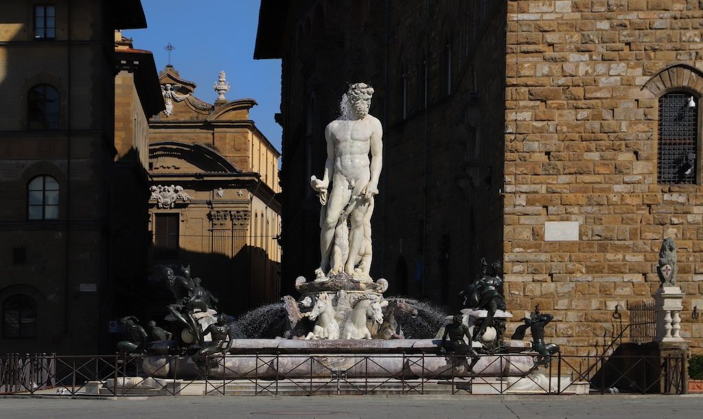 Michelangelo's David statue in Florence's Piazza della Signoria surrounded by protective barriers