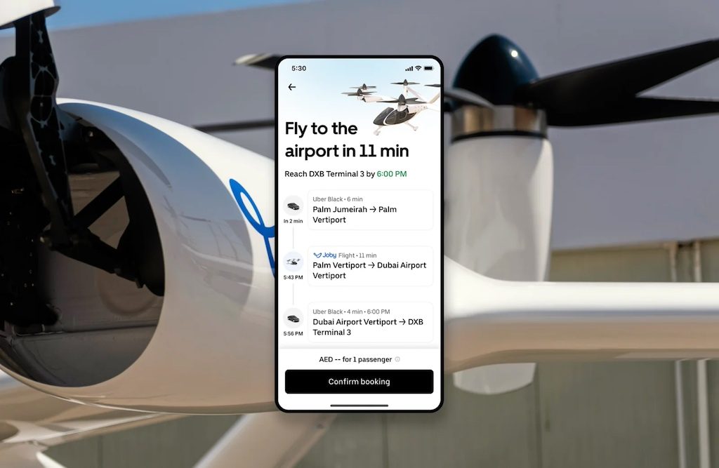 Smartphone displaying air taxi booking app with aircraft in background