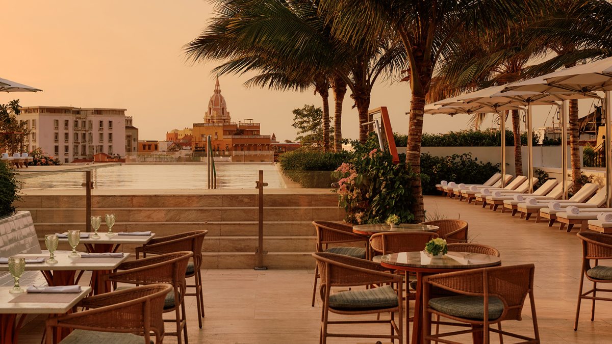 Four Seasons Cartagena terrace with dining area overlooking the walled city at sunset