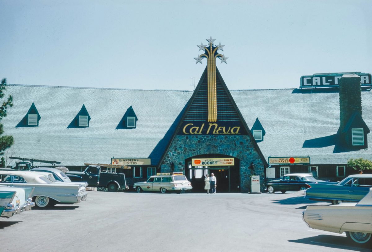 Cal Neva Resort's distinctive peaked roof and signage with parking lot and vintage cars