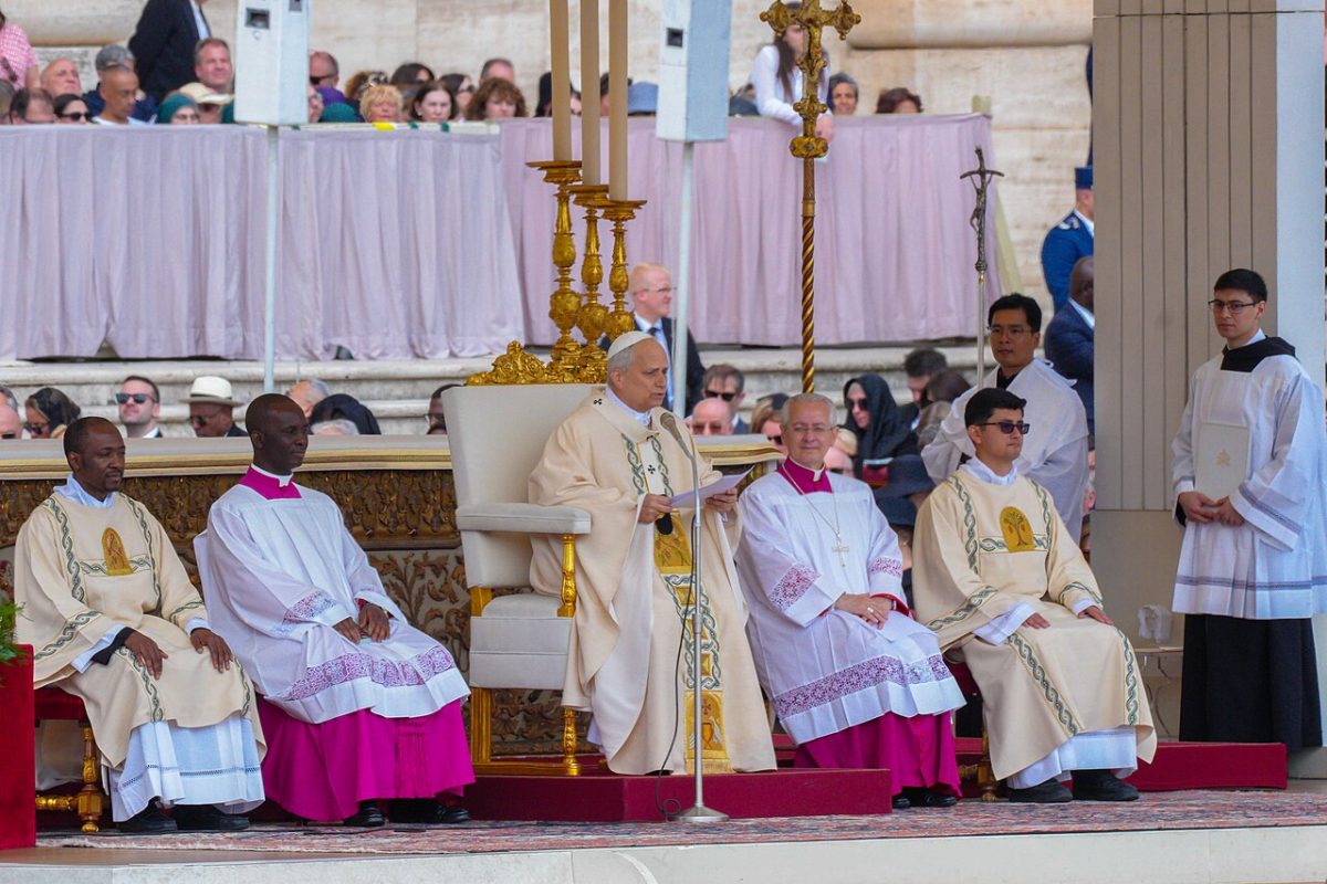 Pope conducting Mass at altar with clergy and attendees in church