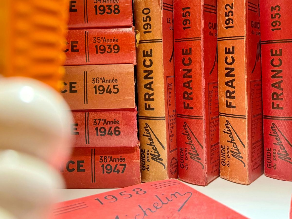 Vintage red Michelin guides from 1938-1953 arranged on a shelf