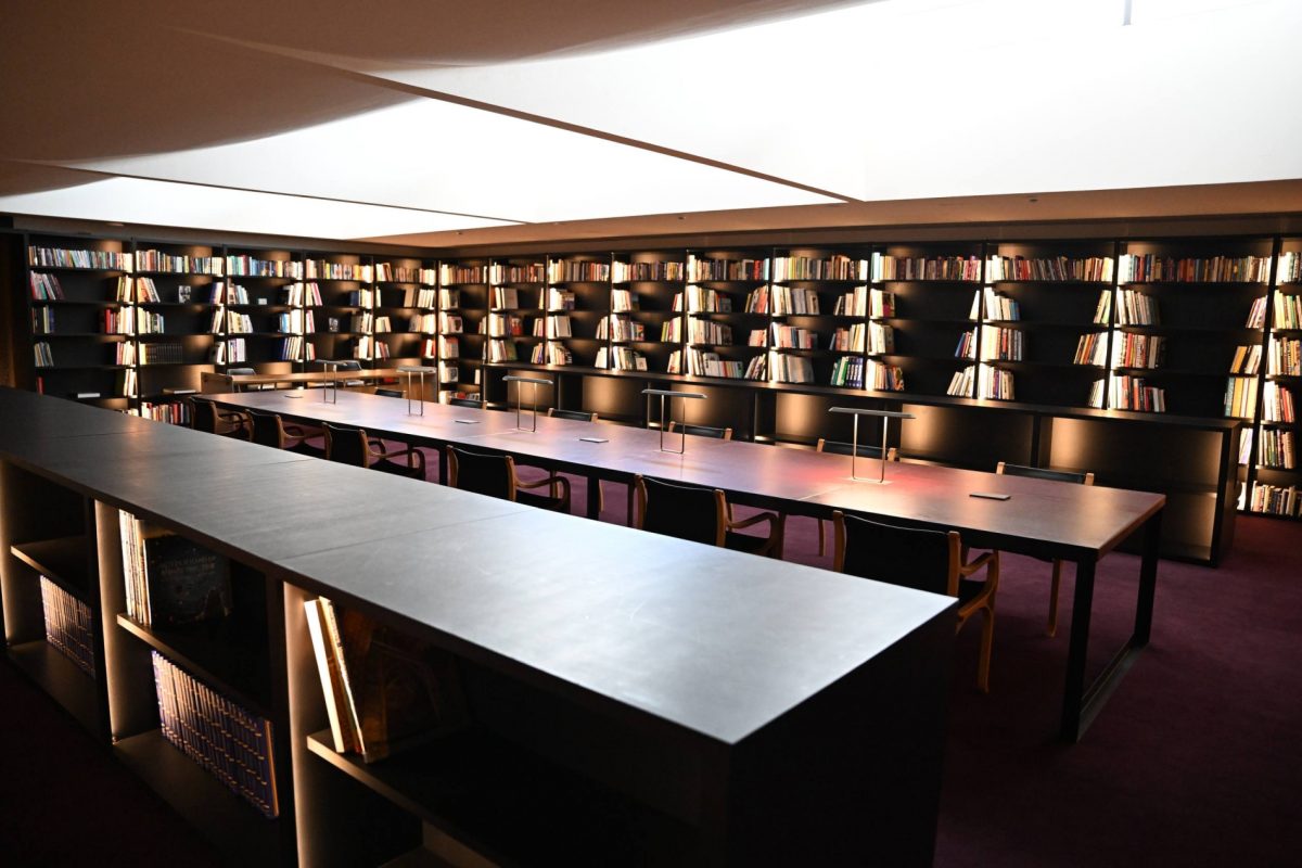 Interior of the Tashkent arts centre, showcasing a long table and extensive bookshelves.