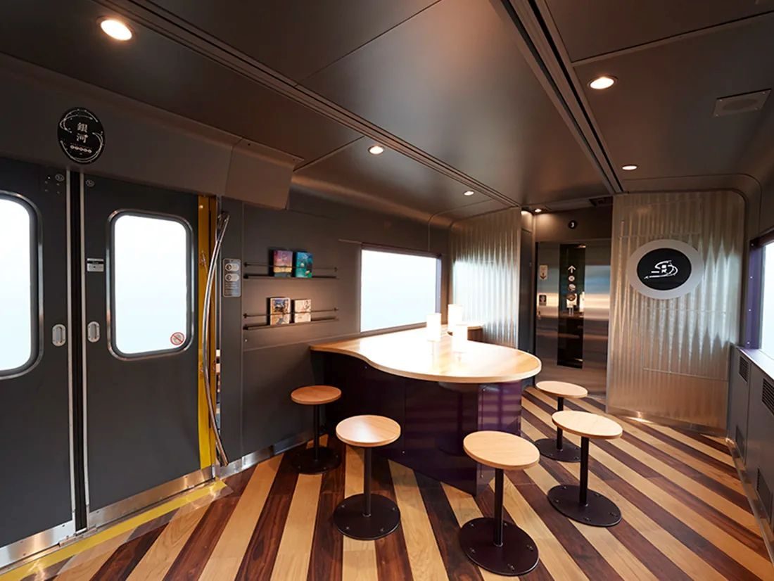 Interior of West Express Ginga sleeper train with wooden flooring and counter seating