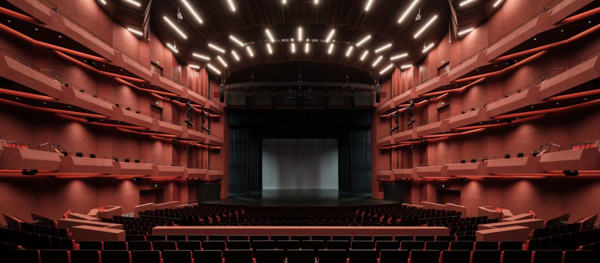Interior view of Shanghai's Grand Opera House, showcasing tiered seating and a large stage.