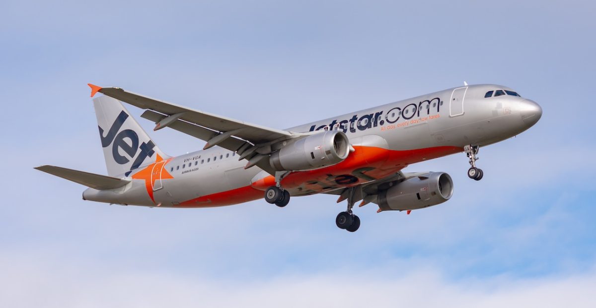 Jetstar Airways Airbus A320 aircraft in flight against blue sky
