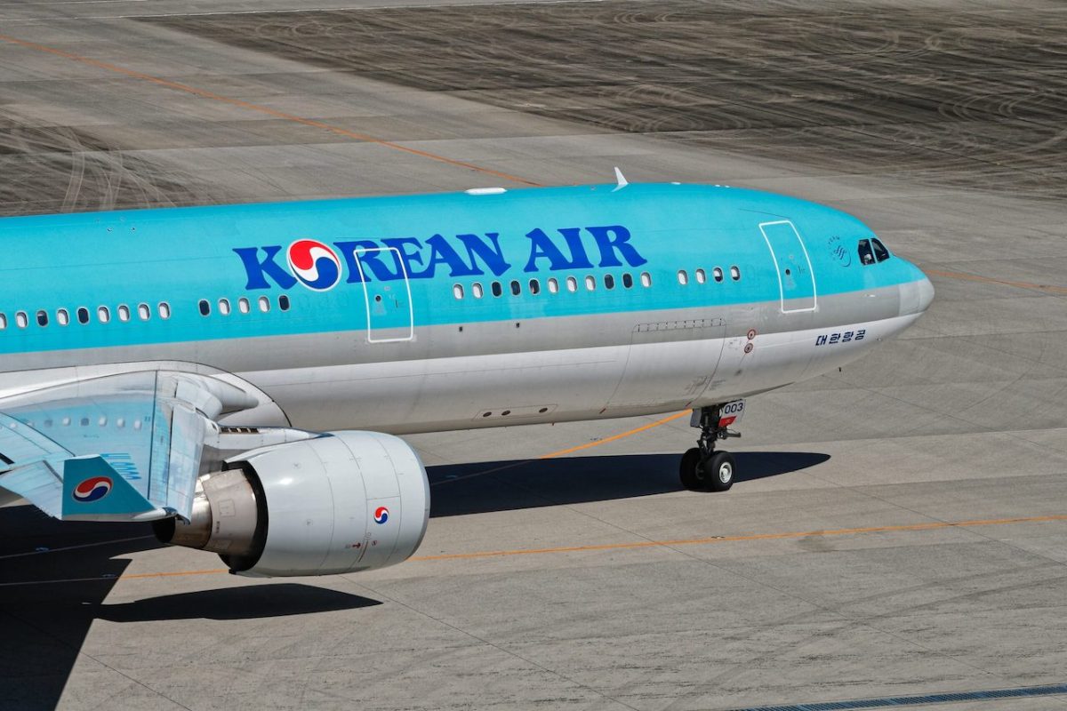 Korean Air aircraft on airport tarmac with turquoise livery and white fuselage