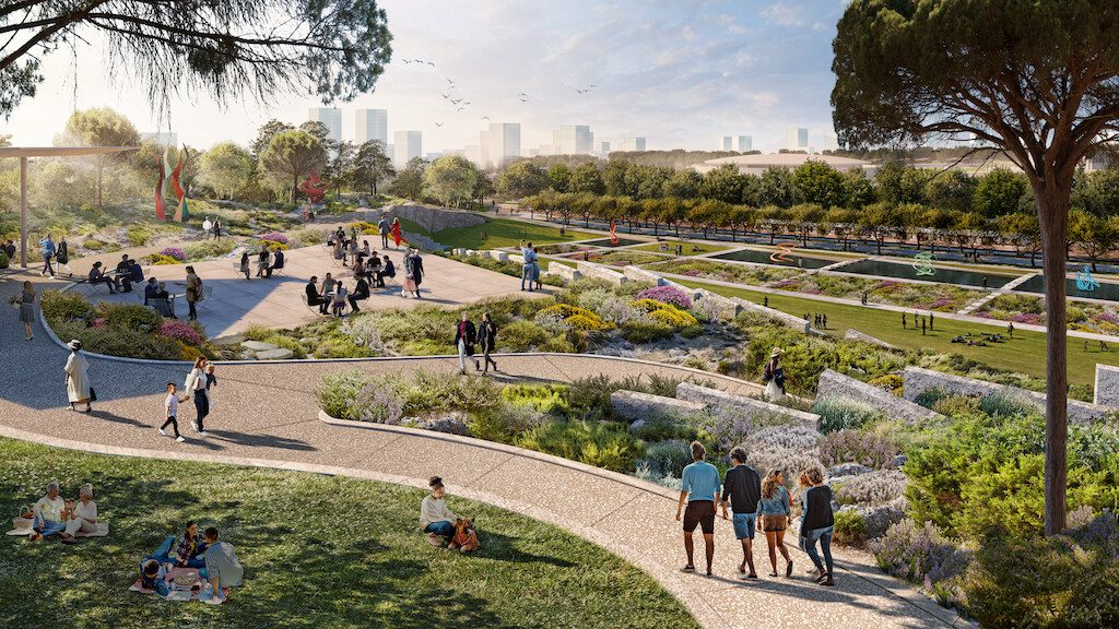 Landscaped park with walking paths, gardens, and water features at The Ellinikon development in Athens