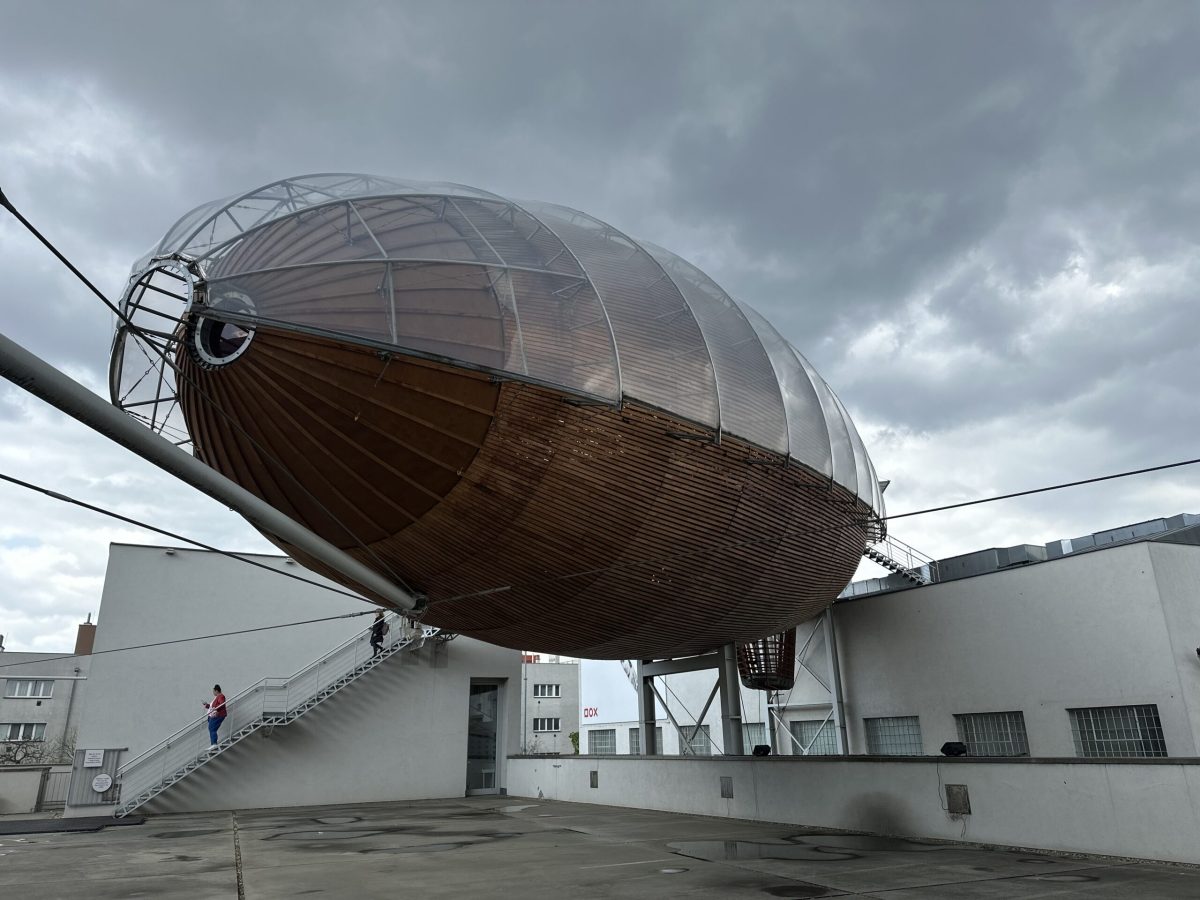 Large metallic airship-shaped structure with stairs, part of Prague's quirky architecture